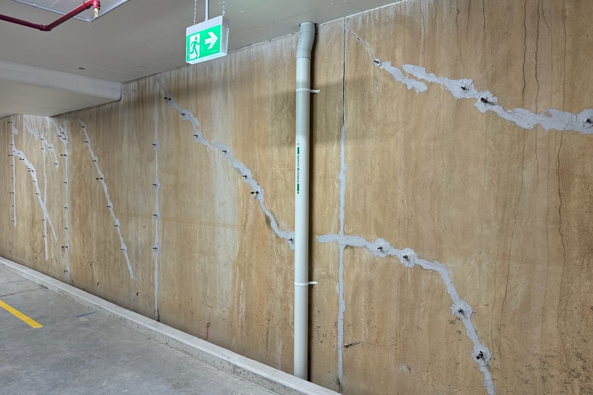 Deep resin injection for reactive soil stabilization beneath foundations